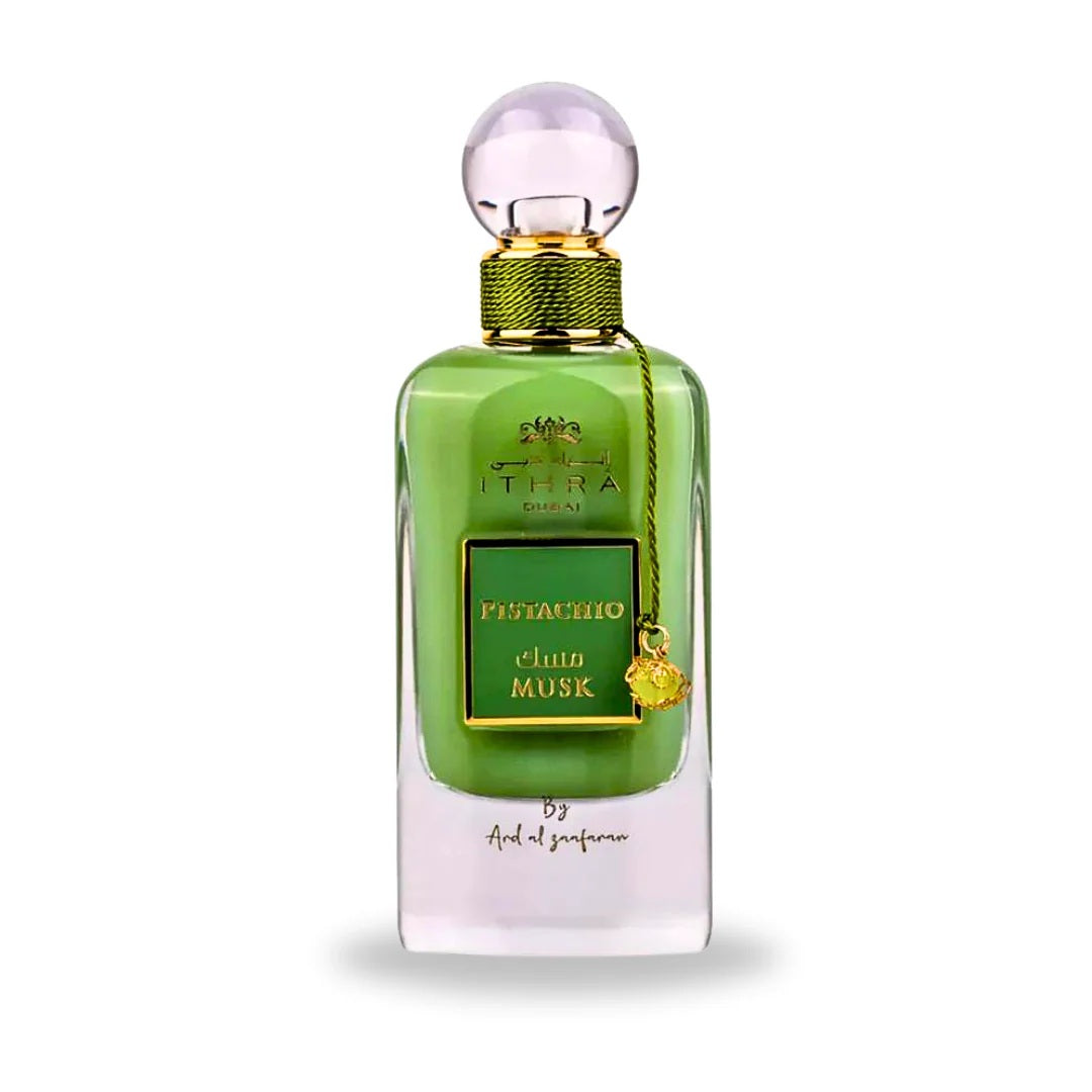 A sleek and luxurious green glass bottle of Pistachio Musk Eau de Parfum from the Ithra Dubai Collection by Ard Al Zaafaran, featuring a gold label and elegant detailing.