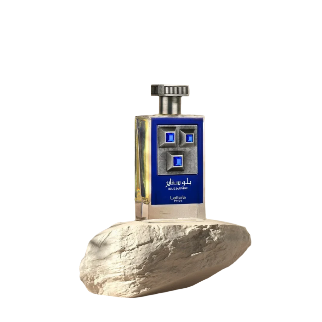 Blue Sapphire Eau de Parfum 3.4 fl oz by Lattafa, featuring a sleek bottle with blue gemstone accents and a metallic cap, resting on a natural stone pedestal.