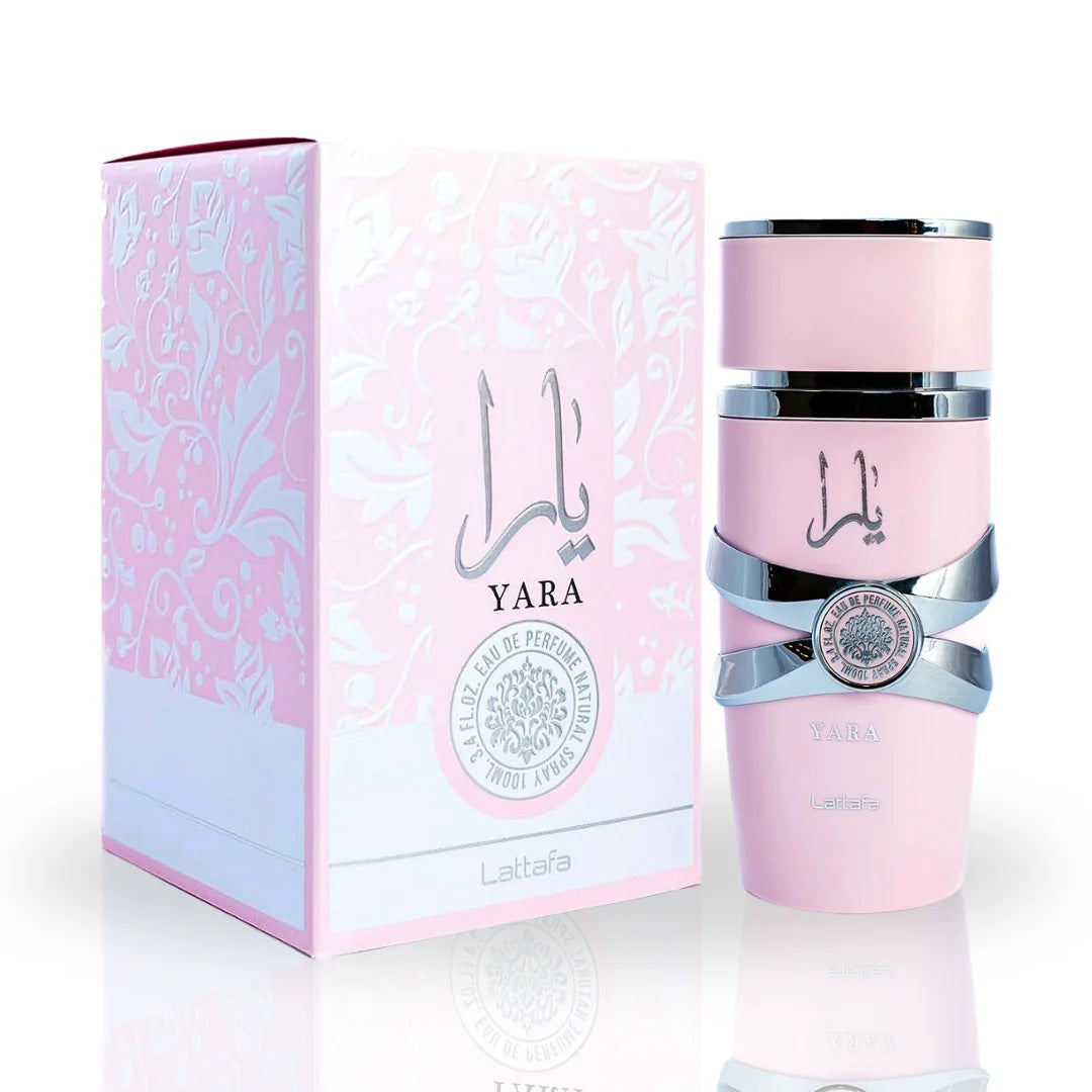 Complete Lattafa Yara perfume collection featuring a pink spray bottle, roll-on perfume, and their matching floral-patterned packaging, elegantly arrange o emphasize luxury and femininity.