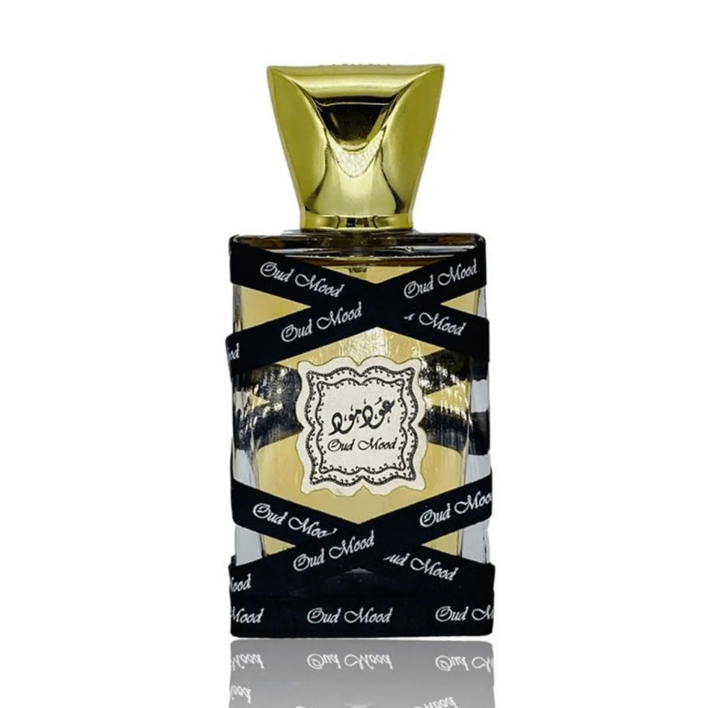A close-up of the Oud Mood Eau De Parfum bottle by Lattafa, featuring a striking black and gold design with elegant Arabic calligraphy.