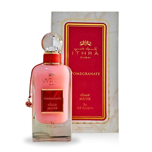 A full set of Pomegranate Musk EDP 100ML by Ard Al Zaafaran, showcasing a pink bottle with red and gold packaging from the Ithra Dubai Collection.