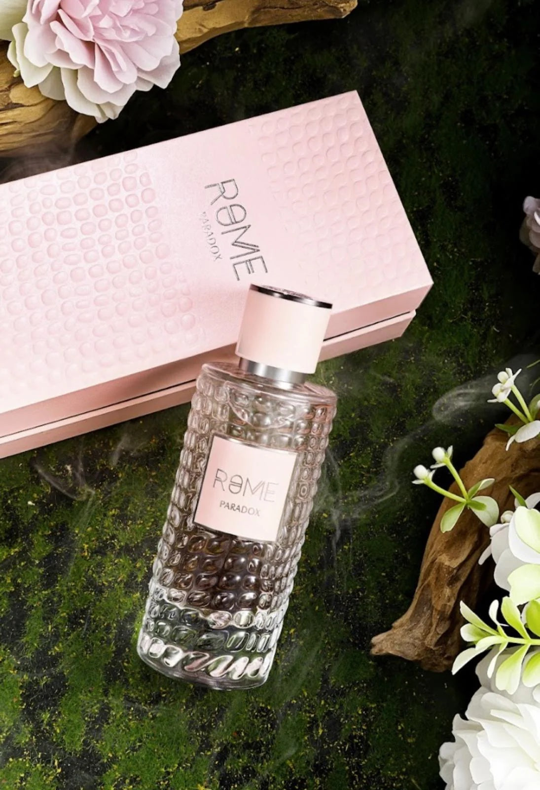 Rome Paradox Eau de Parfum by Bharara Mast Perfume – elegant pink textured box and matching bottle on a floral background, women’s fruity floral perfume with notes of citrus, vanilla, and musk.