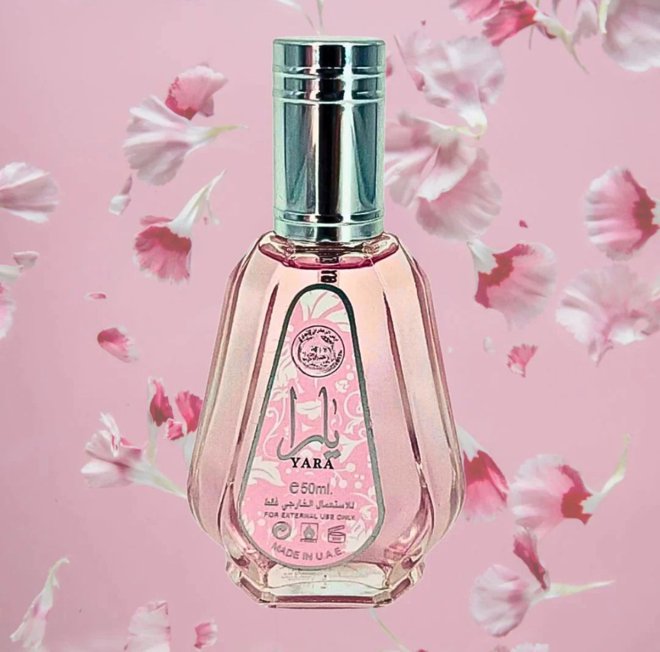 A pink, elegant 50ml Yara perfume bottle with floral background, exuding a sweet and tropical essence.