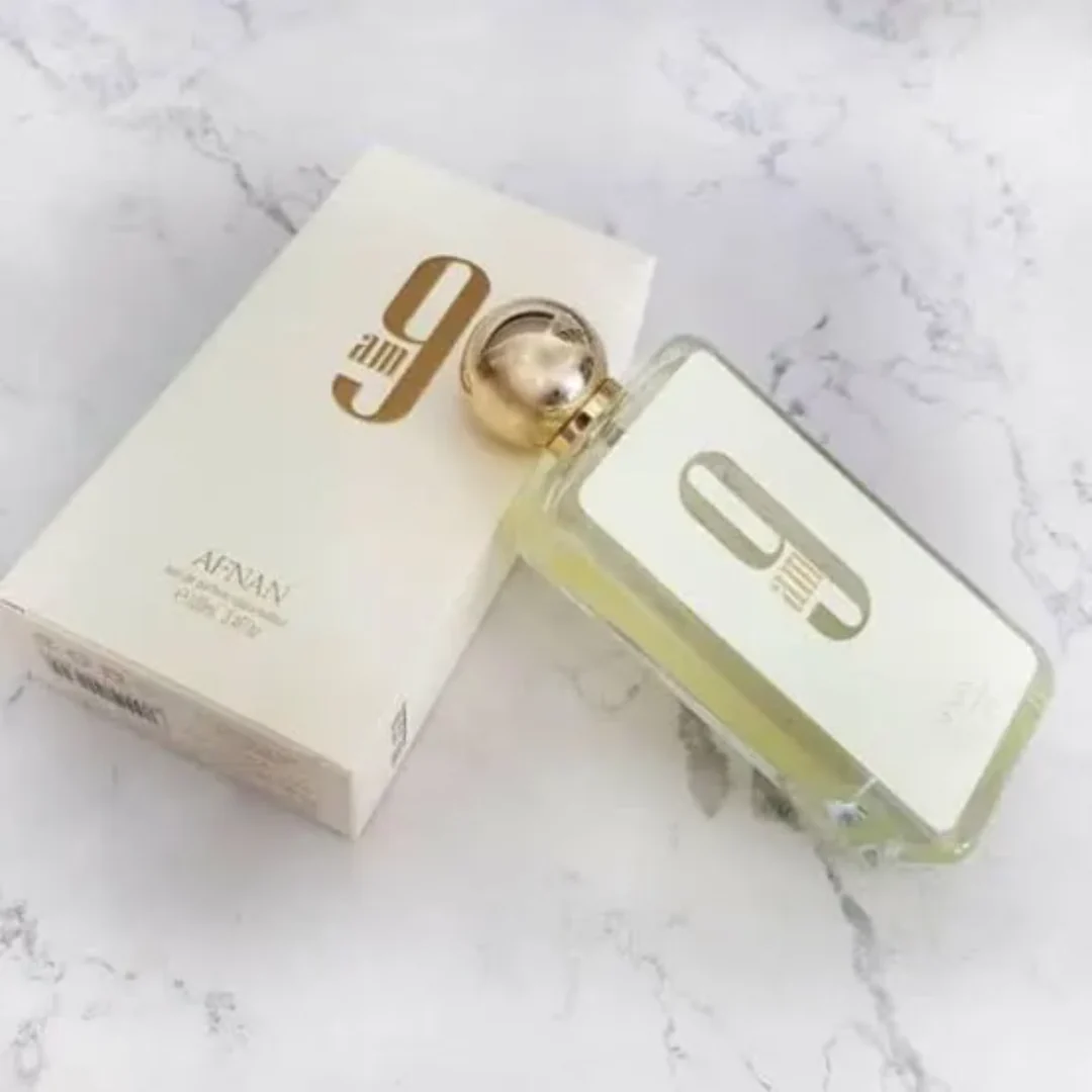 Afnan 9am perfume bottle placed stylishly on a marble surface - An elegant and fresh scent for all occasions.