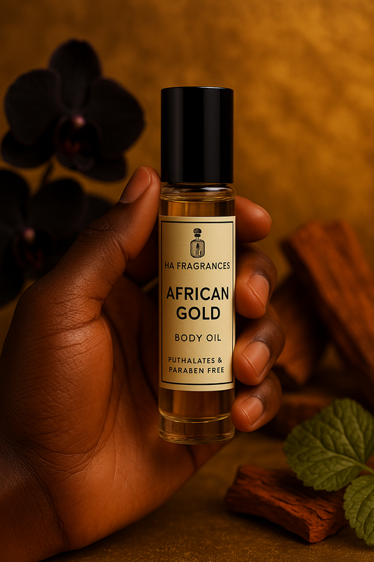 African Gold Body Oil by HA Fragrances held in hand, 10ml roller bottle with black cap, phthalate and paraben free, displayed against a rich background with dark orchids, sandalwood, and mint leaves