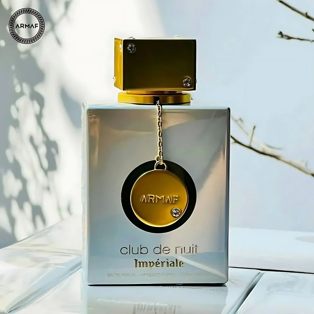 Club De Nuit Imperiale EDP by Armaf - Golden bottle showcased in a sophisticated sunlight setting.