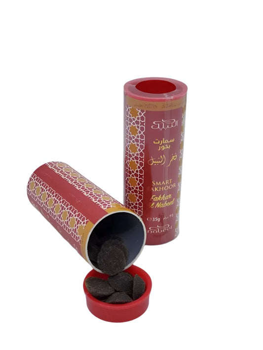 Image of Fakhar Al Nabeel Smart Bakhoor in a vibrant red cylindrical packaging with 35g of bakhoor discs displayed, showcasing premium-quality incense for a luxurious aromatic experience.