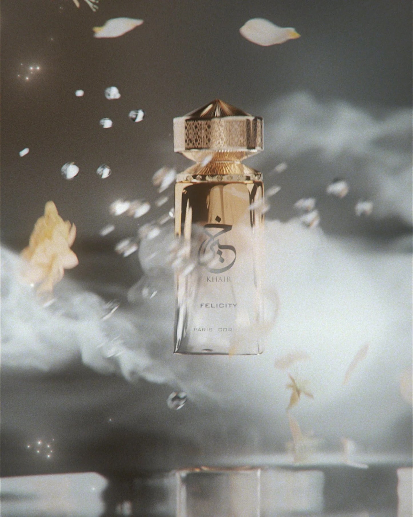 Khair Felicity Eau de Parfum by Paris Corner floating in mist with petals and water droplets in the air