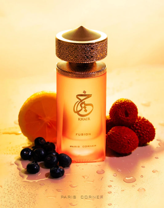 Khair Fusion Lyche Eau De Parfum bottle by Paris Corner surrounded by lychee, lemon, and berries on a golden background