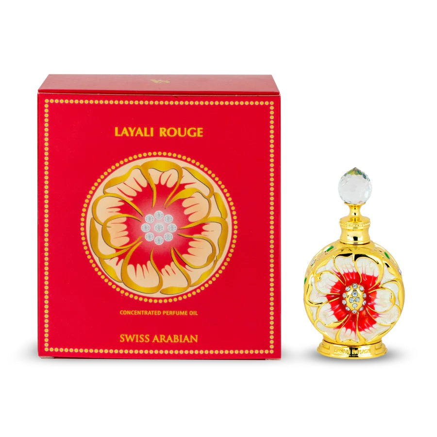 Layali Rouge concentrated perfume oil by Swiss Arabian, displayed alongside its vibrant red and gold floral-themed packaging.