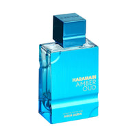 Close-up of Amber Oud Aqua Dubai 100ml bottle by Al Haramain – Elegant metallic blue design for a luxury unisex scent.