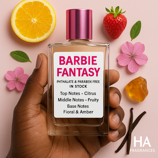 Barbie Fantasy perfume bottle held by a hand with citrus, strawberry, and floral elements on a pink background.