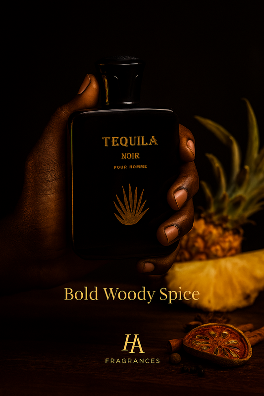 Dark-skinned hand holding Bharara Tequila Noir Eau De Parfum bottle with warm amber lighting, pineapple and spice props, and HA Fragrances logo at the bottom right.
