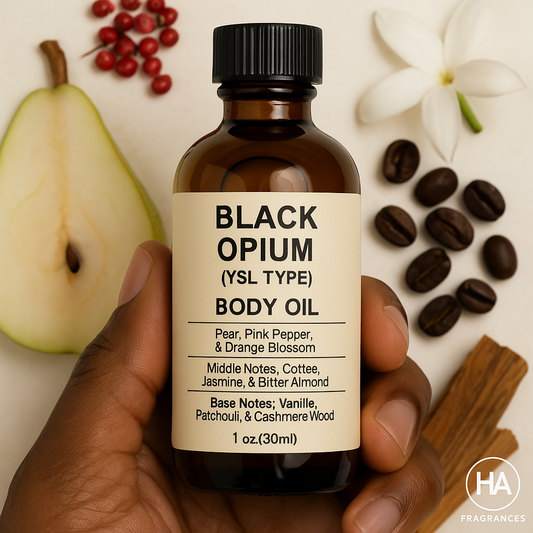 A bottle of Black Opium (YSL Type) Body Oil held by a dark-skinned hand, surrounded by coffee beans, vanilla pods, sliced pear, jasmine petals, and pink pepper, with the HA Fragrances logo in the corner.
