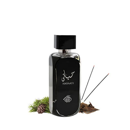 Lattafa Hayaati Black EDP bottle with incense sticks and pinecones, showcasing its warm and spicy fragrance notes.