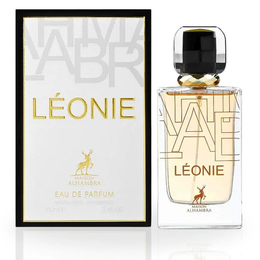 The Léonie Eau De Parfum by Maison Alhambra displayed with its elegant white and black packaging and a sophisticated glass bottle adorned with golden details.