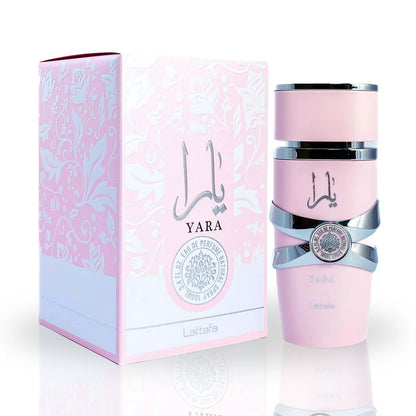 Complete Lattafa Yara perfume collection featuring a pink spray bottle, roll-on perfume, and their matching floral-patterned packaging, elegantly arrange o emphasize luxury and femininity. 