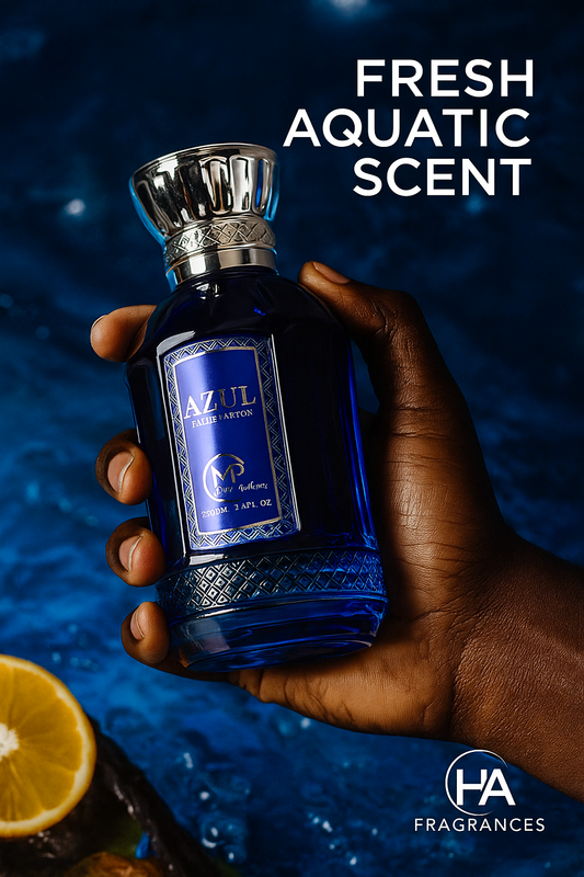 Dark-skinned hand holding blue Mast Azul Eau De Parfum bottle by Bharara with ocean-inspired background, lemon slice, and water droplets, featuring HA Fragrances logo and text overlay ‘Fresh Aquatic Scent’.