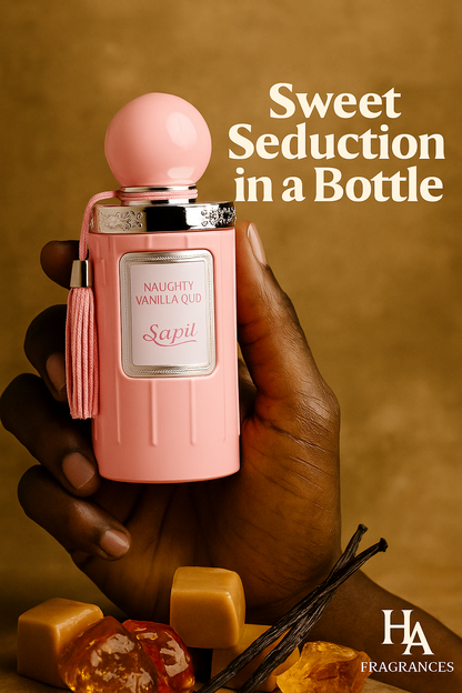 Dark-skinned hand holding pink Sapil Naughty Vanilla Oud perfume bottle with caramel cubes, vanilla pods, and amber stones on a golden background featuring HA Fragrances branding.