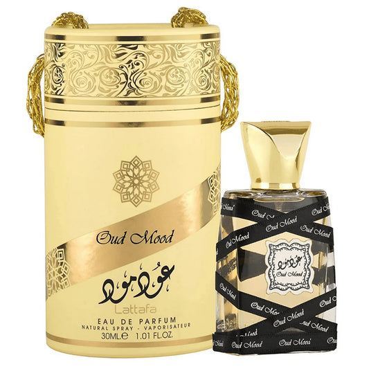 The Oud Mood Eau De Parfum by Lattafa displayed with its ornate golden packaging and sleek bottle design, featuring bold black and gold accents and intricate detailing.





