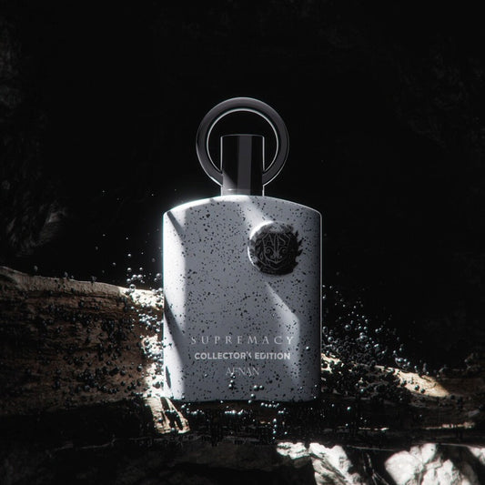 Afnan Supremacy Collector's Edition EDP bottle under spotlight with a bold, artistic splash effect – luxury chypre fruity men's fragrance