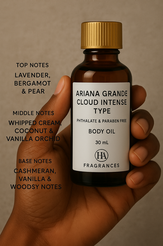 Dark-skinned hand holding HA Fragrances 30ml bottle labeled “Ariana Grande Cloud Intense Type” body oil, with gold cap and labeled notes of lavender, bergamot, pear, whipped cream, coconut, vanilla orchid, cashmeran, vanilla, and woodsy notes.