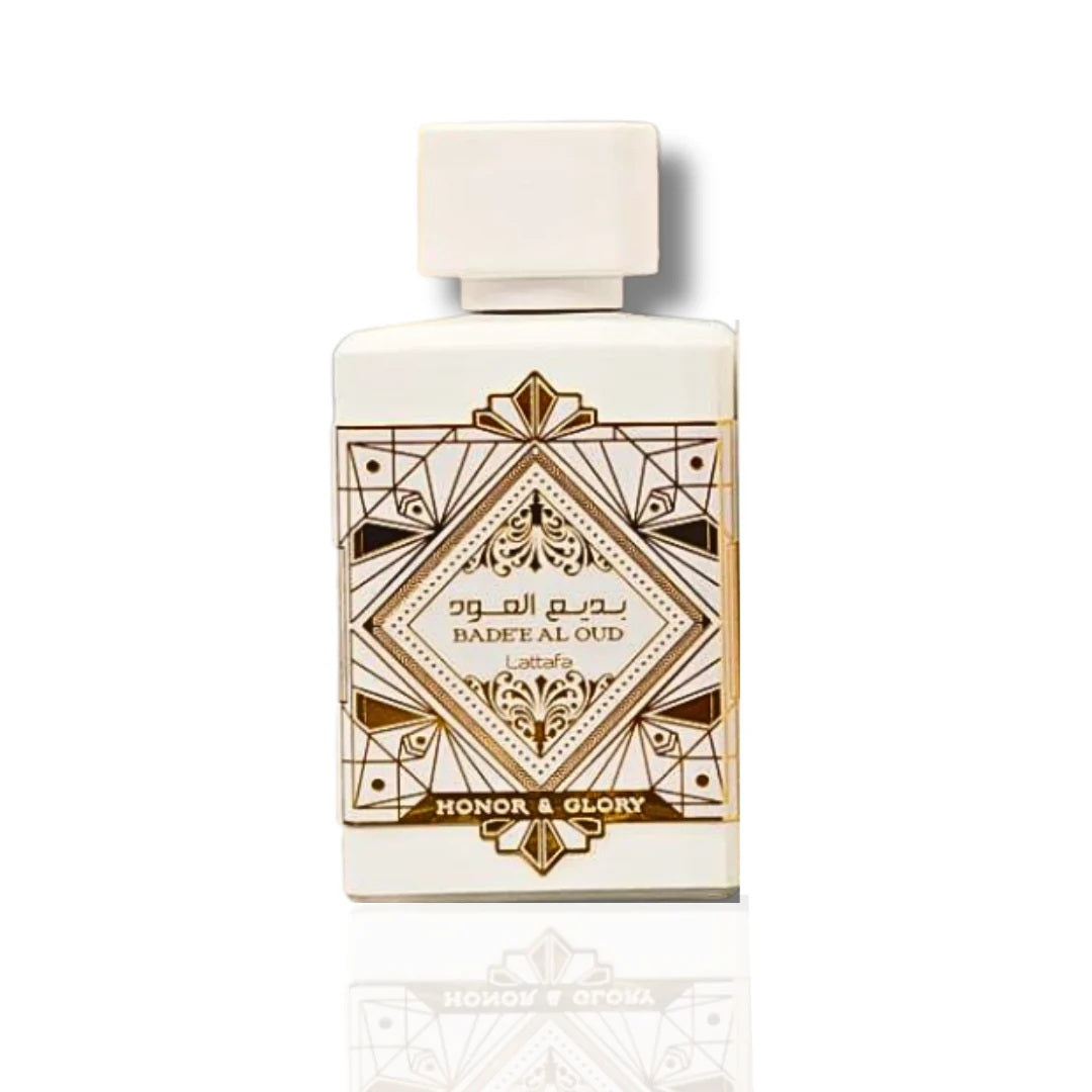 Bade’e Al Oud Honor & Glory Eau De Parfum by Lattafa, showcasing a sleek white bottle adorned with gold geometric patterns and elegant accents.