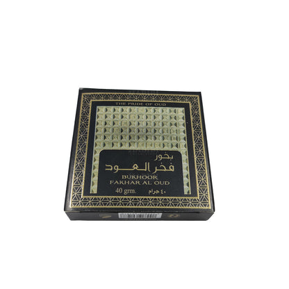 Bukhoor Fakhar Al Oud by Ard Al Zaafaran, a premium 40g Arabian incense featuring a rich oud fragrance, displayed in an elegant black and gold packaging with geometric patterns.