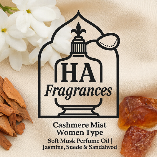 Cashmere Mist Women Type perfume oil by HA Fragrances in a clear bottle with beige tones, surrounded by jasmine flowers, sandalwood pieces, amber resin, and soft cashmere fabric on a white background.