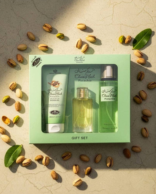 Choco Musk Pistachio 3-Piece Gift Set with perfume, shower gel, and body mist — nutty gourmand fragrance by HA Fragrances surrounded by pistachios.