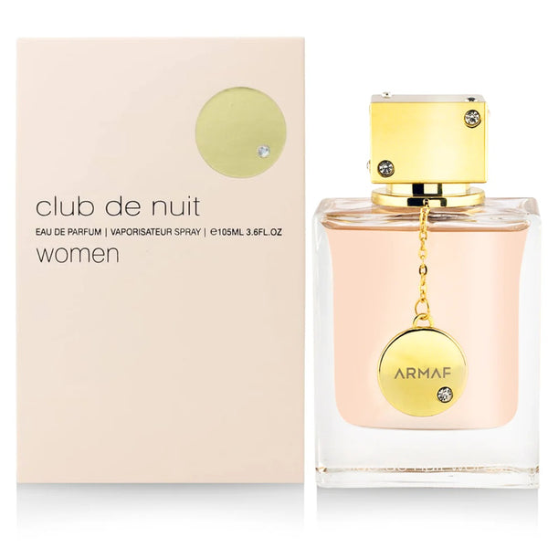 A sleek bottle of Club De Nuit for Women EDP (105ML) by Armaf with an elegant gold cap, presented next to its matching beige and gold box.