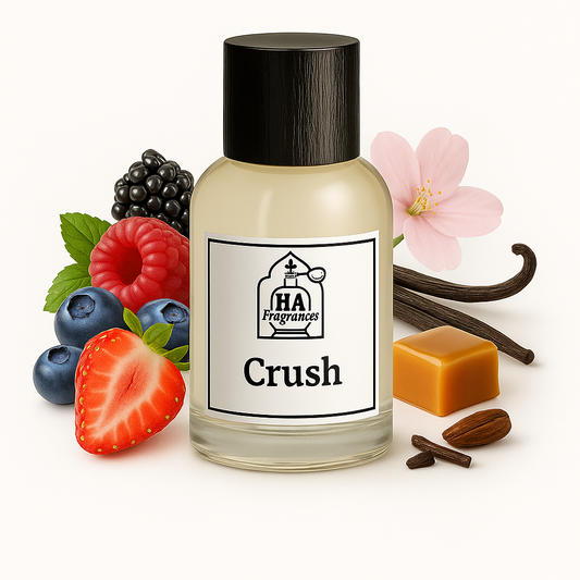 Crush Type perfume oil by HA Fragrances in a clear bottle, surrounded by strawberries, blueberries, raspberries, blackberries, caramel candy, vanilla bean, and a soft pink flower on a white background.