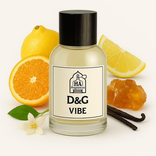 D&G Vibe Type perfume oil by HA Fragrances in a clear glass bottle, surrounded by orange slices, lemon wedges, amber resin, vanilla bean, and white floral on a white background.