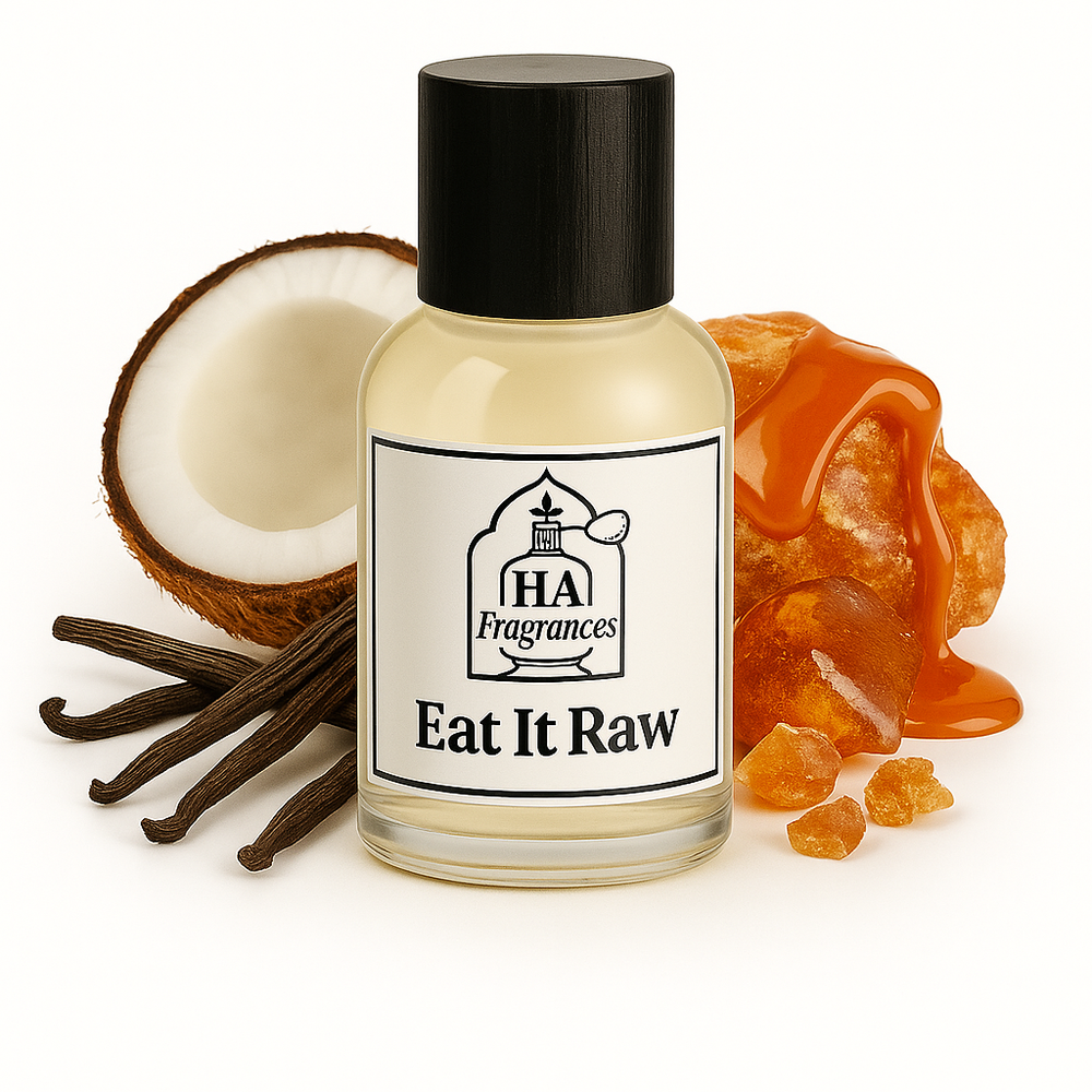 Eat It Raw Inspired perfume oil by HA Fragrances in a clear glass bottle, surrounded by vanilla beans, caramel drizzle, coconut halves, and amber resin on a white background.