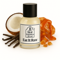 Eat It Raw Inspired perfume oil by HA Fragrances in a clear glass bottle, surrounded by vanilla beans, caramel drizzle, coconut halves, and amber resin on a white background.
