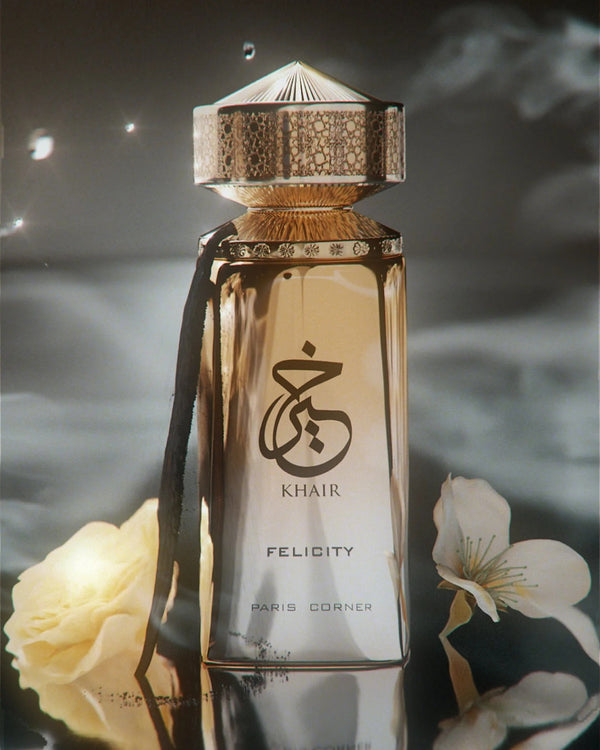 Felicity by Khair perfume bottle by Paris Corner, elegant gold design surrounded by flowers and soft light