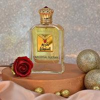 Hareem Al Sultan perfume bottle by Khadlaj styled with a red rose and golden decorative ornaments in a glamorous setting.