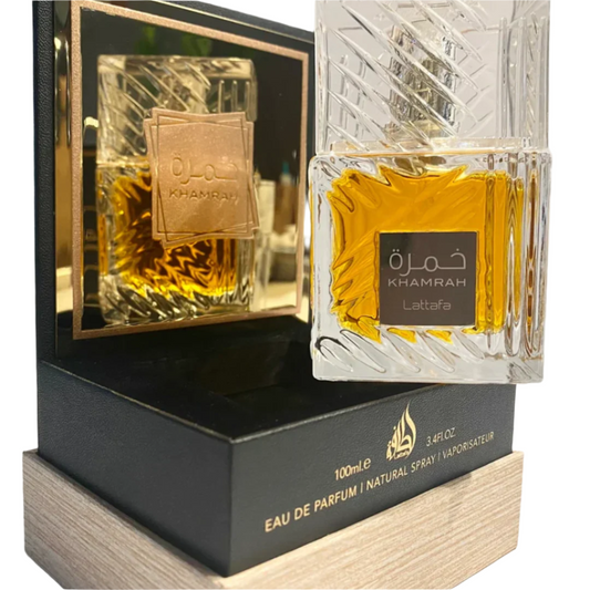 Lattafa Khamrah Eau de Parfum 100ml - Luxurious crystal bottle with golden accents displayed in an elegant black and gold packaging.