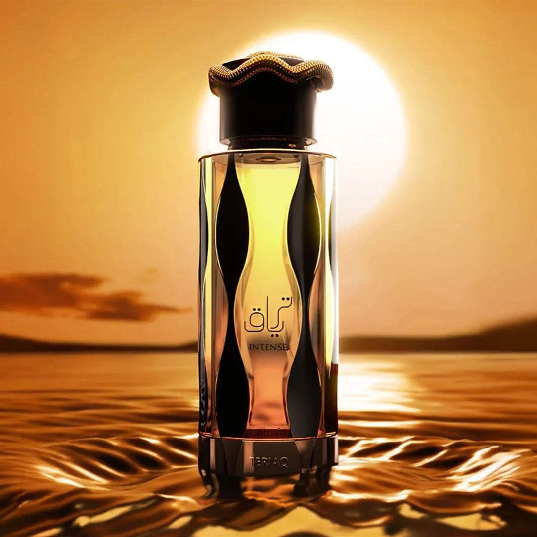 Lattafa Teriaq Intense perfume bottle glowing in front of a golden sunset over shimmering water – luxury Arabian fragrance.