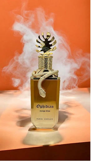 Elegant Ophidian Mango Bliss perfume by Paris Corner with gold cap and snake detail, captured with a smoky backdrop for a luxurious presentation.