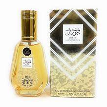 Oud Mood Eau De Parfum 50ML by Ard Al Zaafaran, featuring a luxurious golden bottle and matching ornate gold packaging with intricate details.