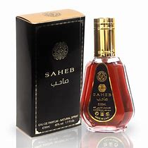 Saheb Eau De Parfum 50ML by Ard Al Zaafaran, featuring a sleek amber-colored bottle with gold accents, paired with an elegant black and gold packaging.