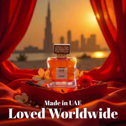 Elixir Intense by Sapil perfume bottle displayed at sunset with Dubai skyline in the background