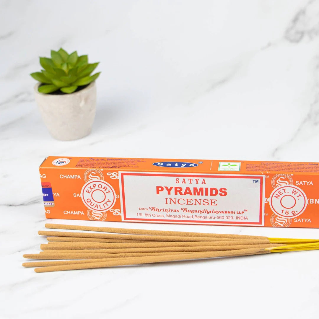 Satya Pyramids Incense 15g single pack displayed on a marble surface with neatly arranged incense sticks, highlighting its natural and calming fragrance.