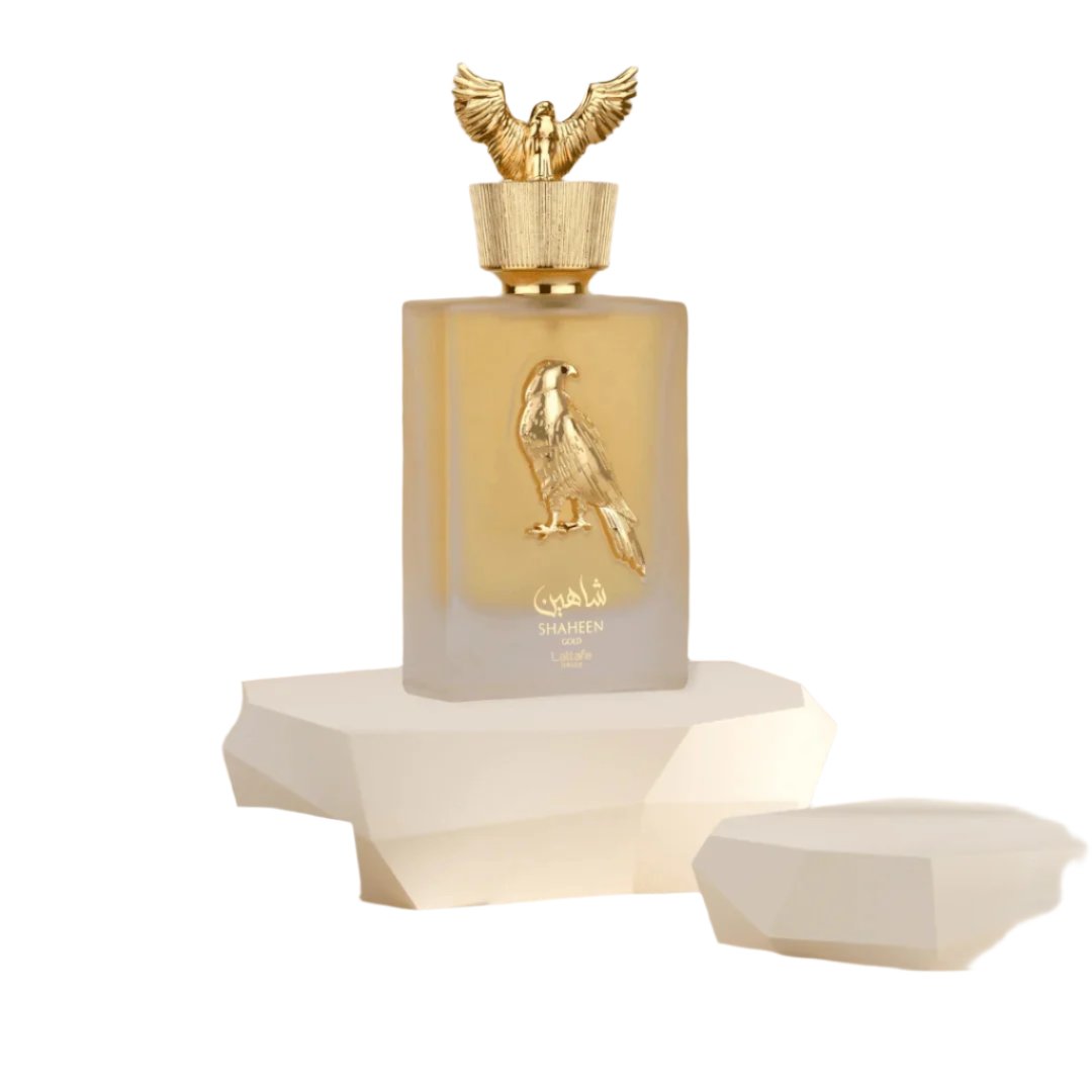 Shaheen Gold Eau de Parfum by Lattafa Pride, featuring an elegant gold-accented bottle with a falcon design and a majestic golden cap, 100ML.