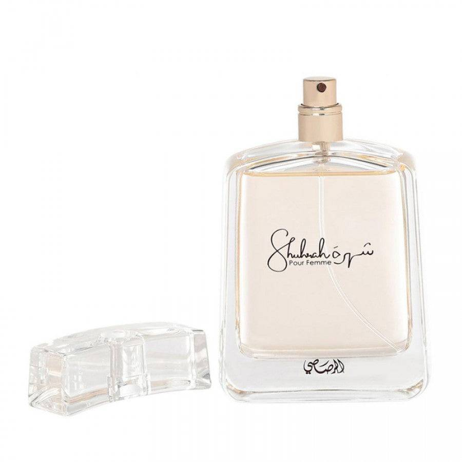 Shuhrah Pour Femme perfume by Rasasi, highlighting its sleek and elegant 90ml bottle on a textured background