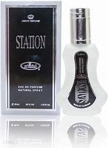 Station Eau De Parfum 35ml by Al-Rehab, featuring a sleek frosted bottle with a silver cap and an elegant black and silver box, representing its refreshing citrus and oriental fragrance.